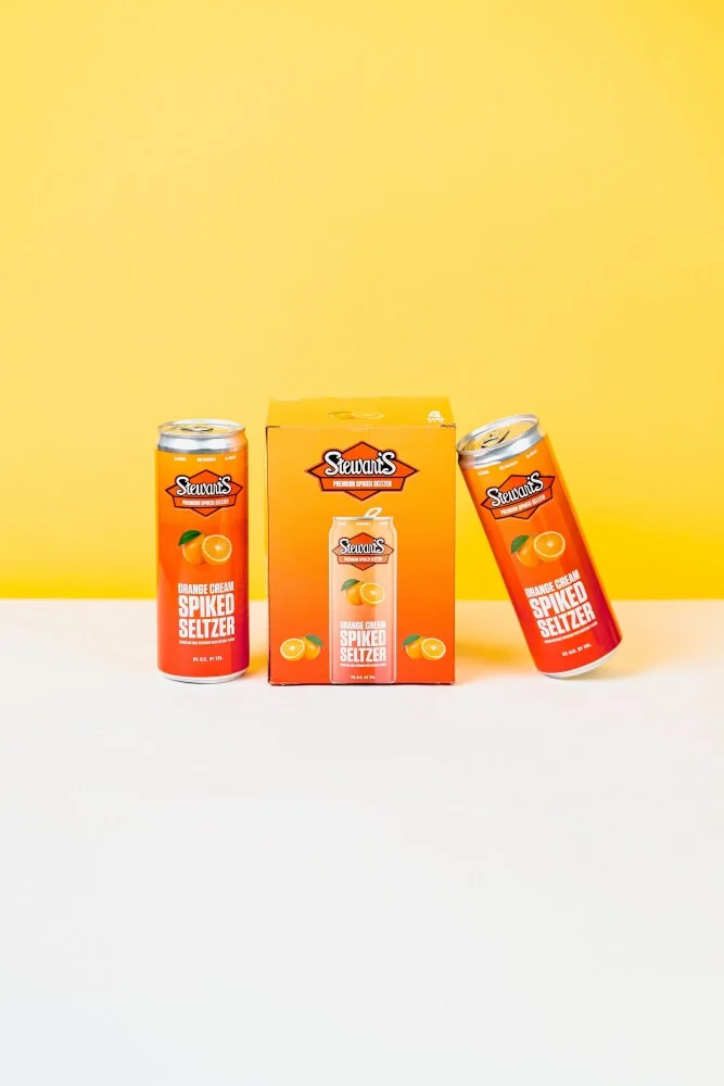 Stewart’s Orange Cream box and cans on yellow and gray surfaces